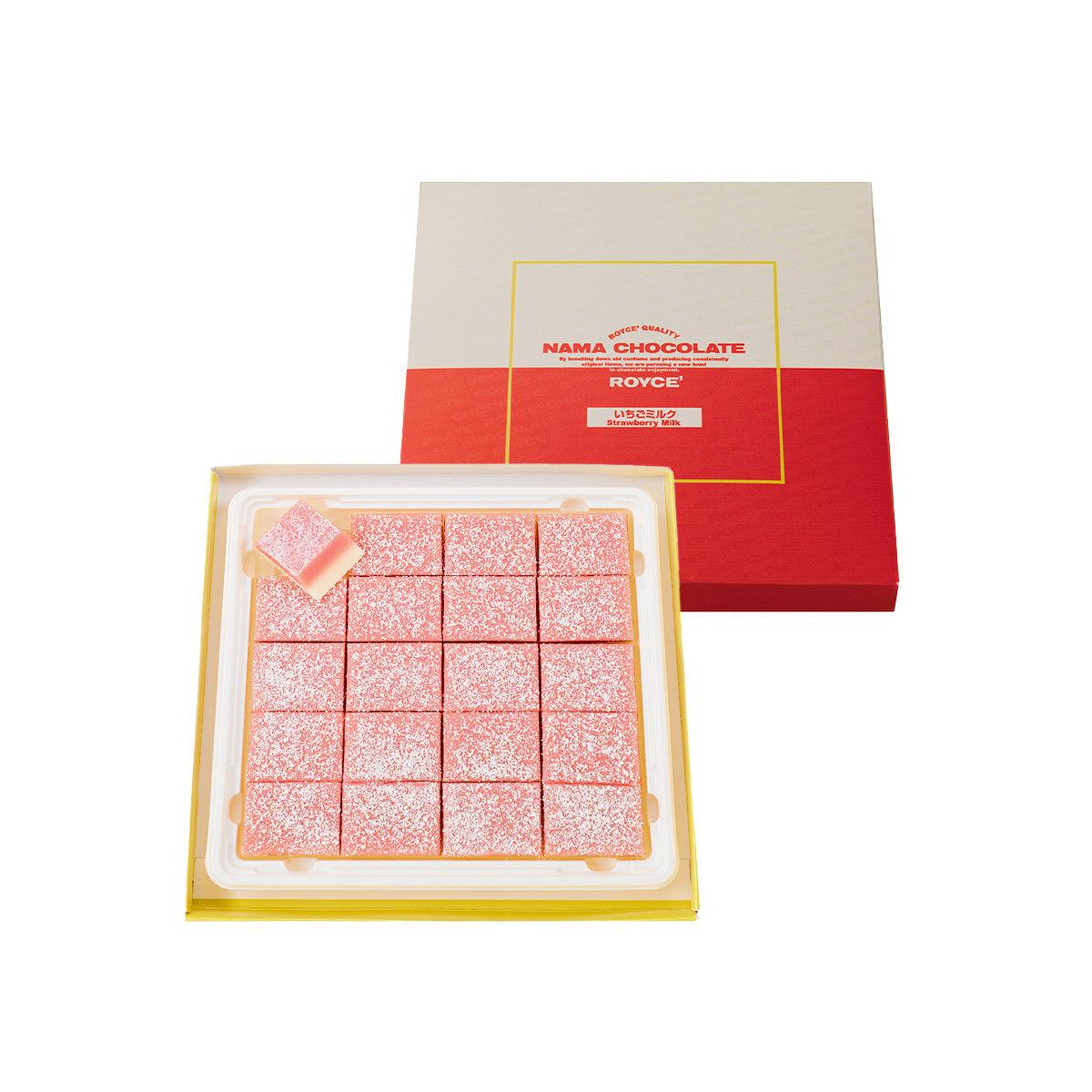 Strawberry milk nama chocolate assortment in open box, pink square bites