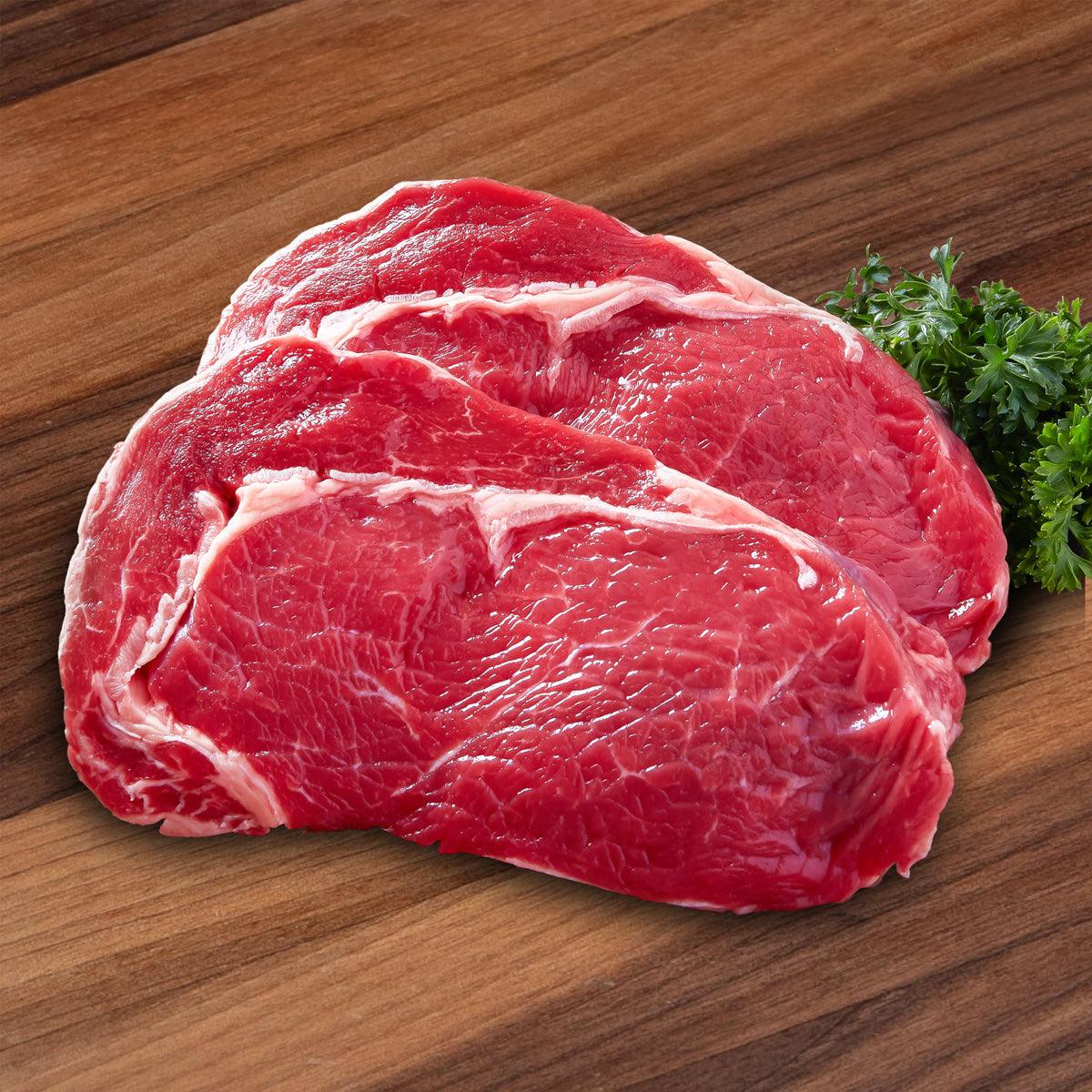 Raw beef ribeye steak, thick cut with white marbling and trimmed fat (200g)