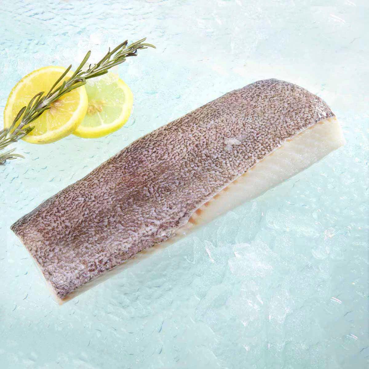 Previously frozen Greenland halibut slice, skin-on, speckled purple-brown with white flesh