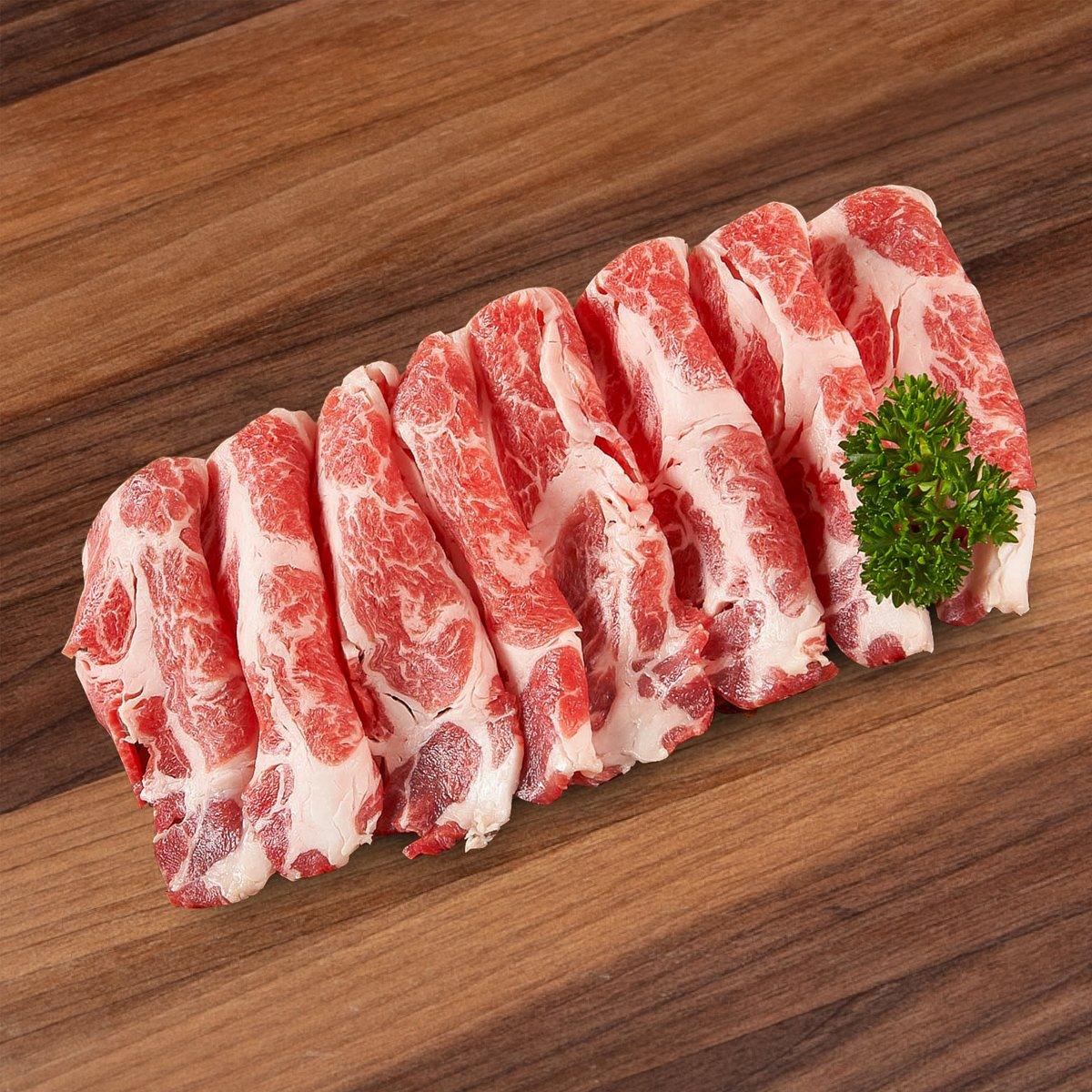 Marbled sukiyaki pork slices fanned, red and white, with parsley garnish