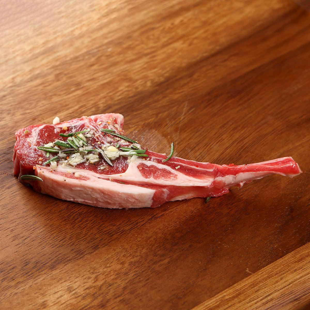 Bone-in chilled lamb rack chop with rosemary and garlic seasoning