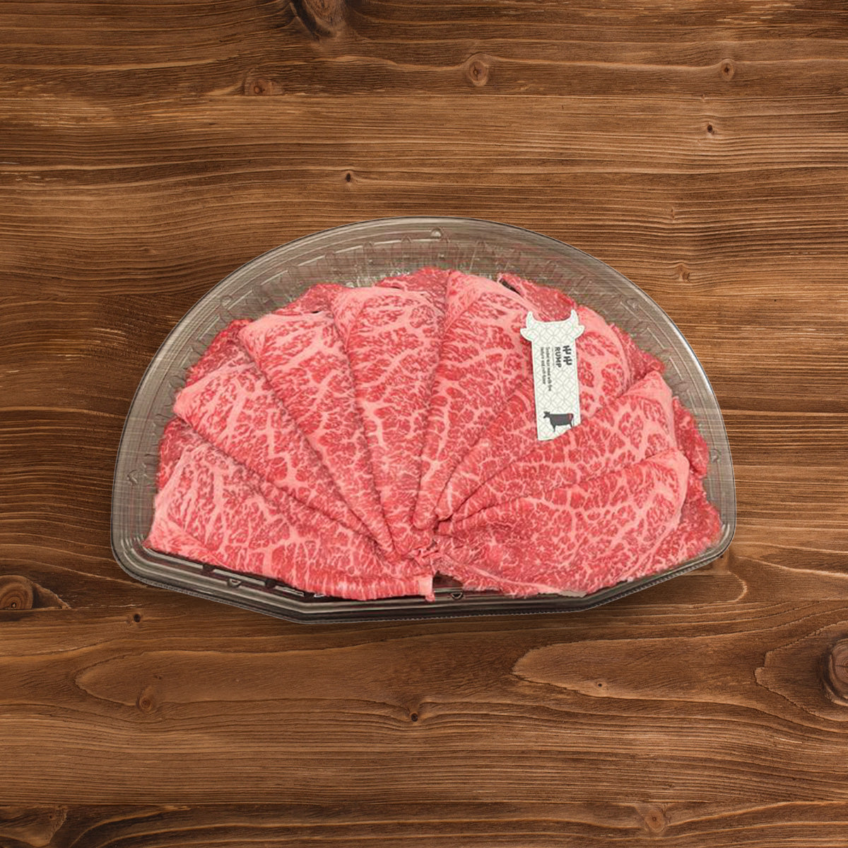 Chilled wagyu sukiyaki beef in clear plastic tray, red marbled slices