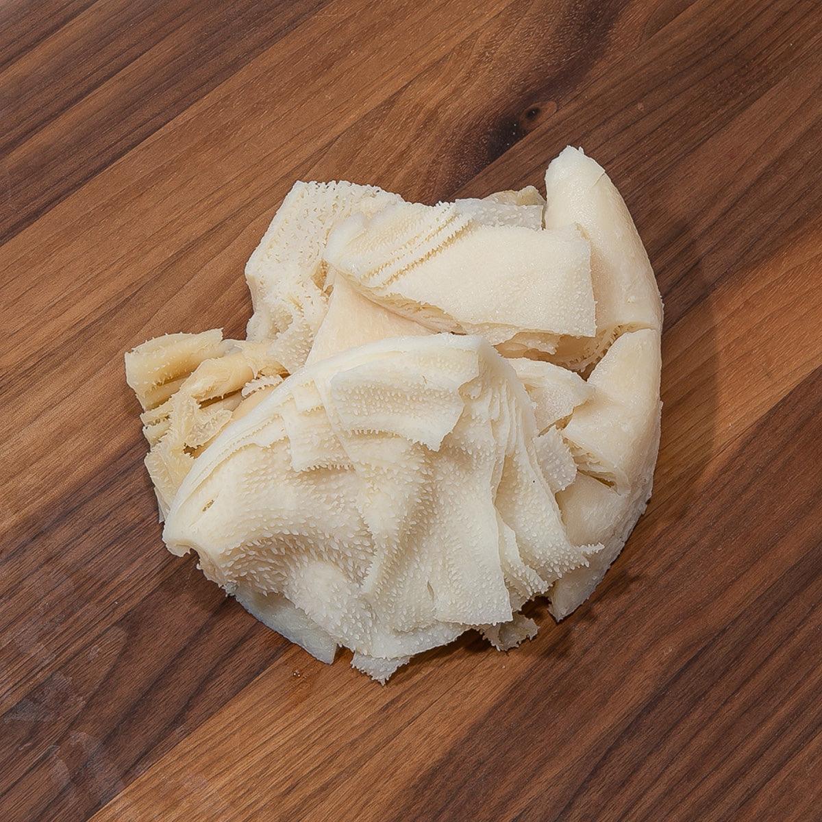 Frozen beef omasum tripe, pale white chopped pieces