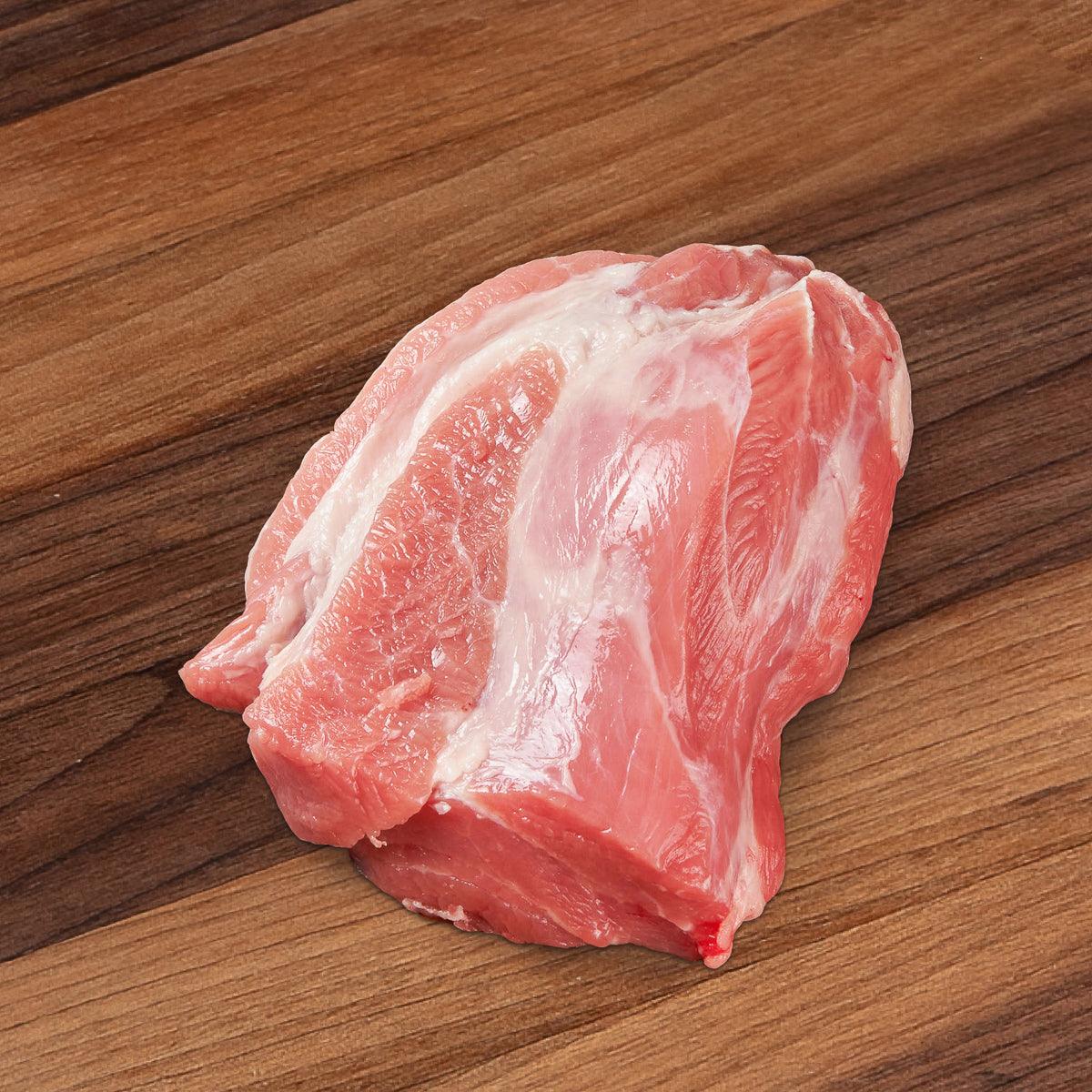 Raw pork neck collar cut with pink meat and white fat marbling