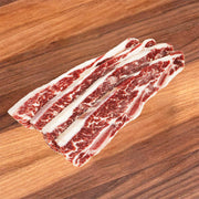 Frozen beef short ribs with marbled red meat and thick white fat strips