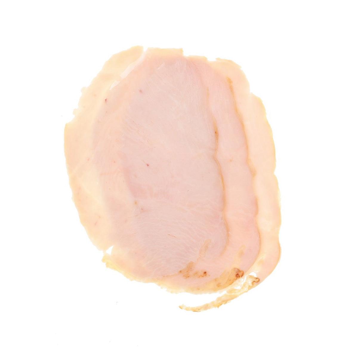 Hickory smoked turkey breast slice, rounded pale pink with browned edge