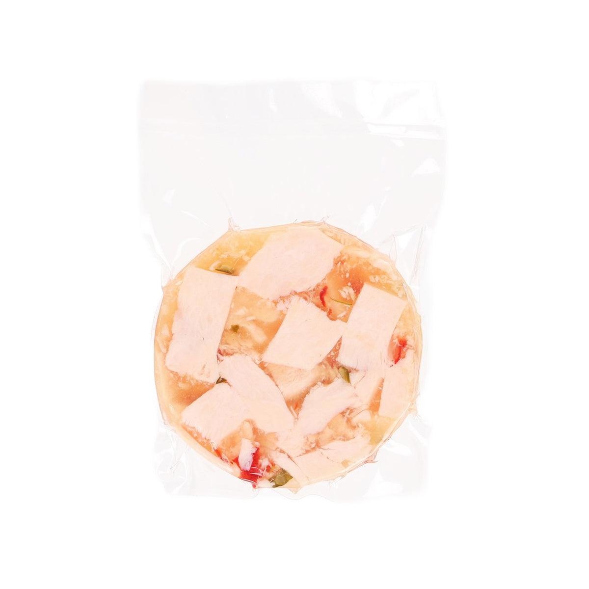 Chicken aspic terrine with pepper pieces, molded in clear plastic bag