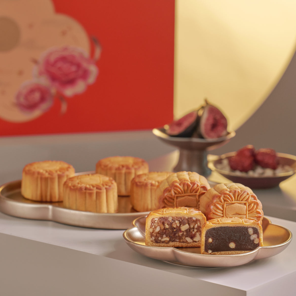 Assorted vegetarian mooncakes on plates with sliced pastries