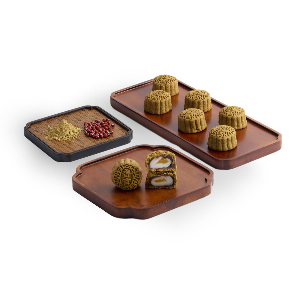 Assorted mini mooncakes on trays, with round textured tops and visible filling centers.