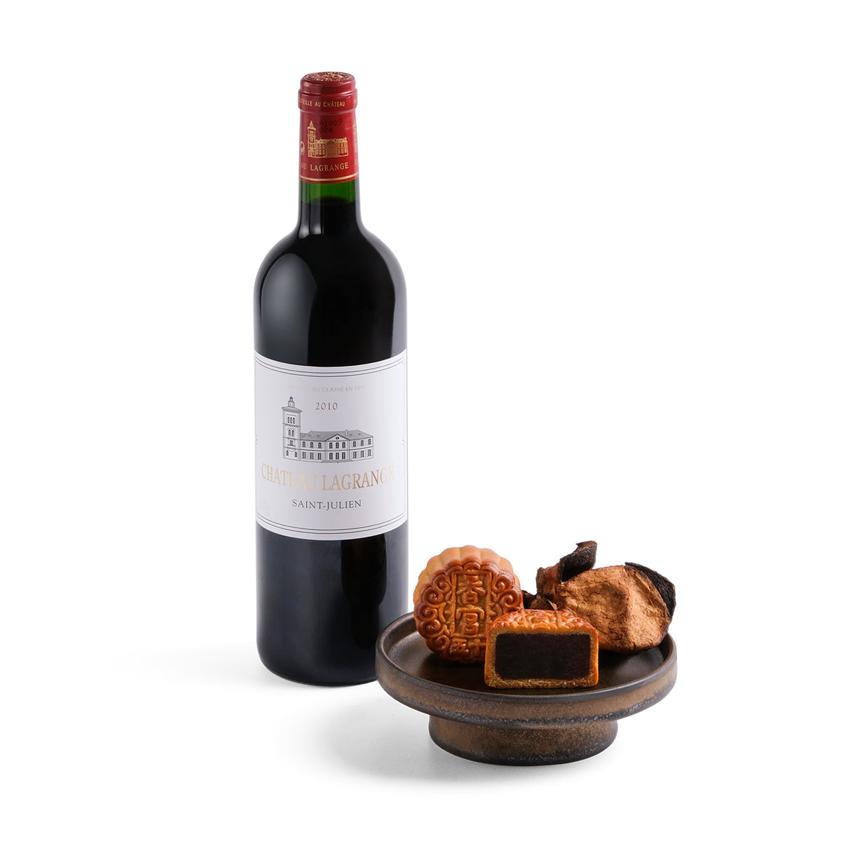 Wine bottle and mooncake gift set with pastries on a round serving dish