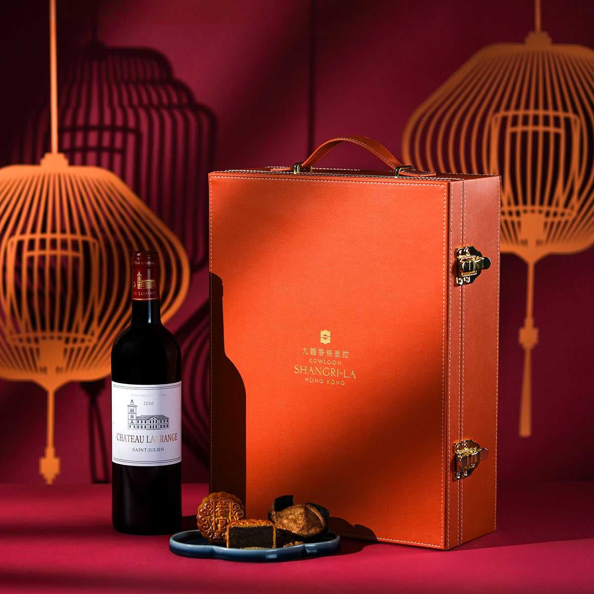 Wine bottle and red gift box set with handle, plus mooncakes on a round dish
