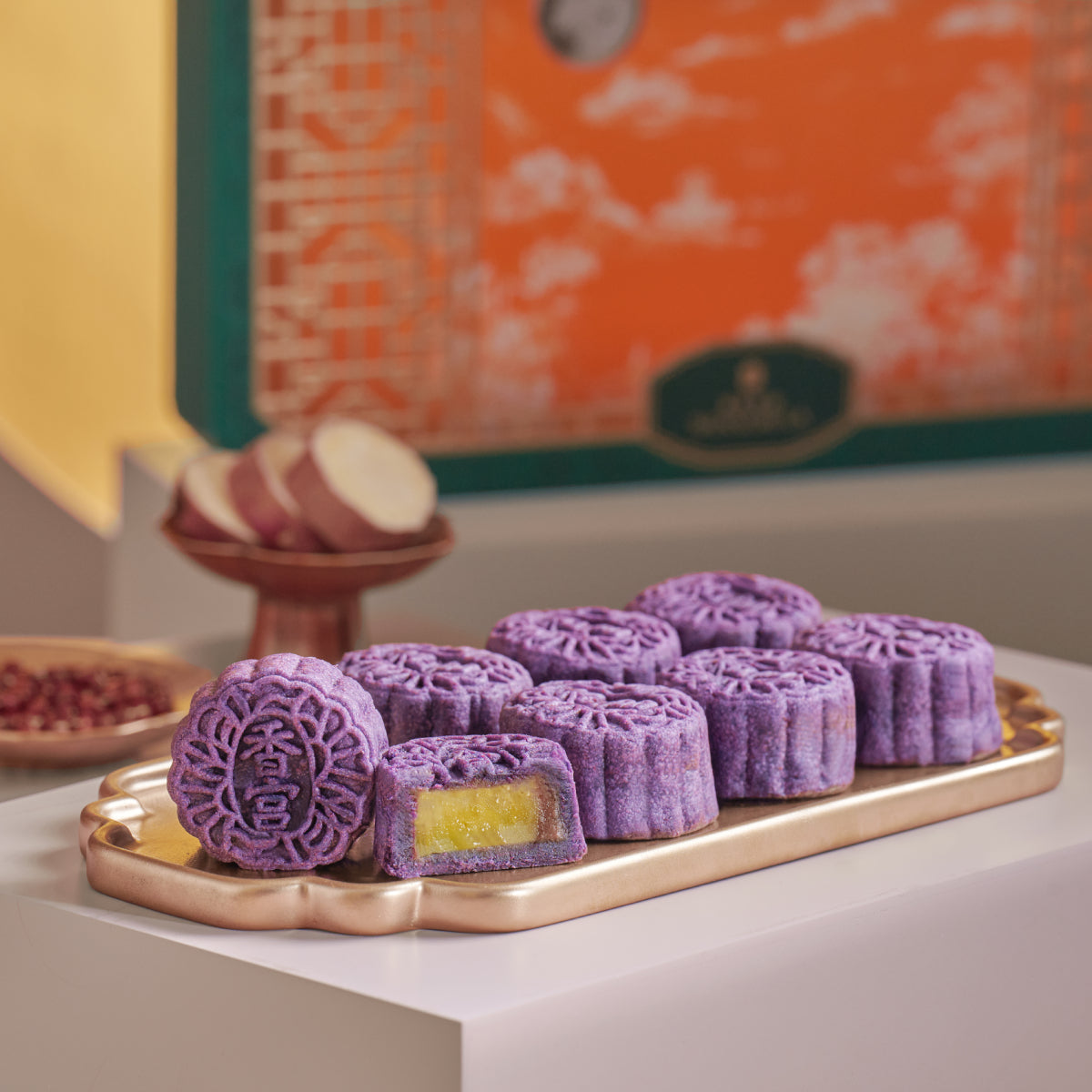 Boxed mini mooncakes with purple patterned tops and red bean filling
