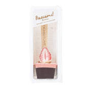 Bitter chocolate spoon candy with strawberry-shaped piece in clear wrapper