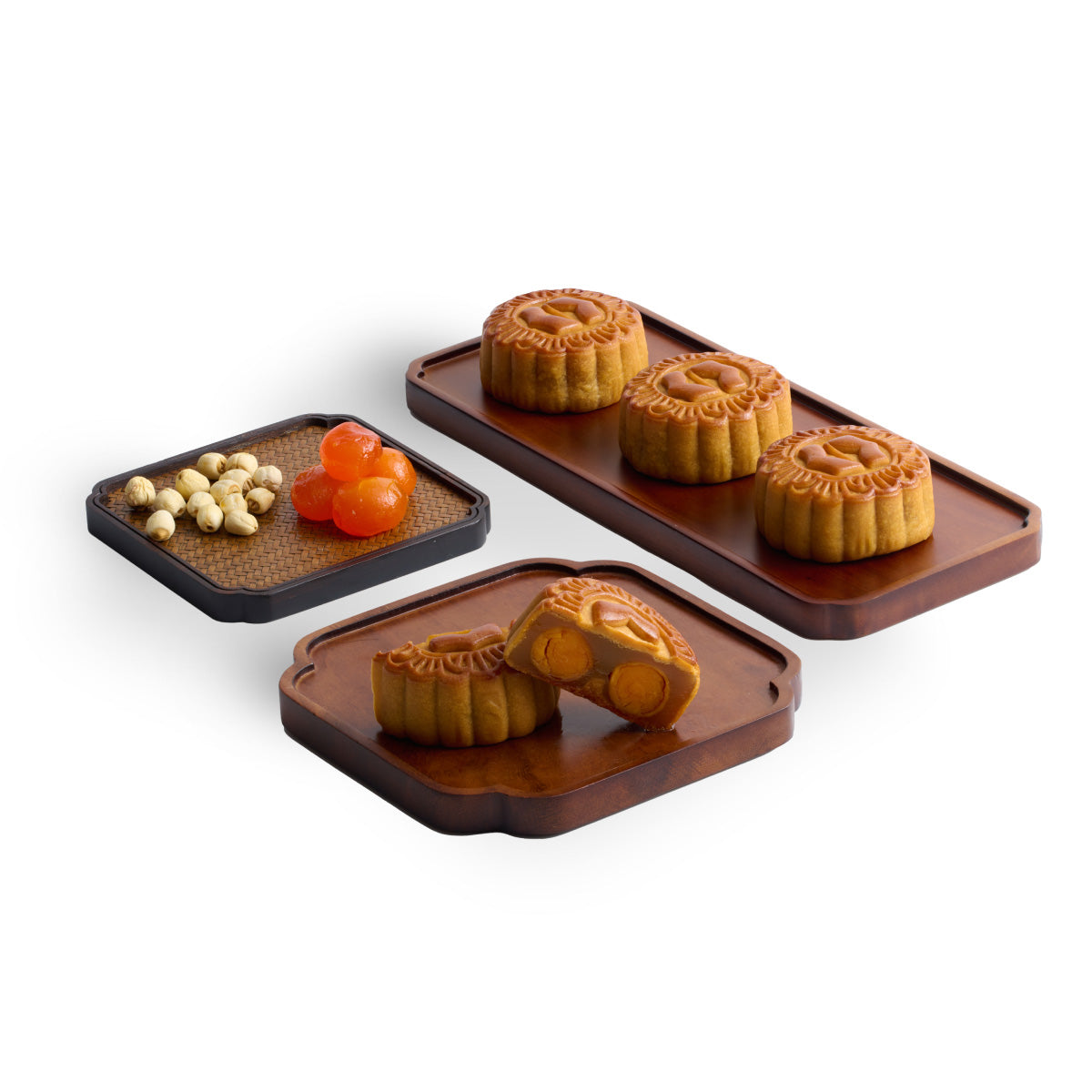 Assorted mooncakes with molded patterns and egg yolk centers on dark trays