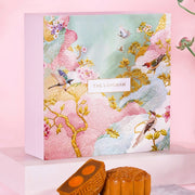 Mooncake gift box with floral bird design and two orange mooncakes on tray