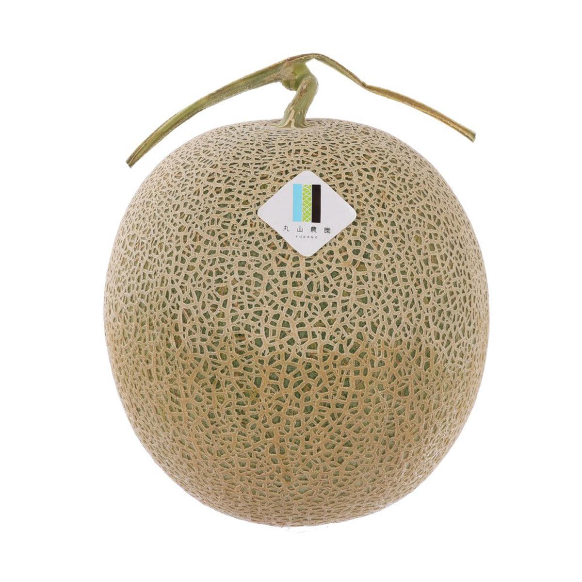 Round light-tan melon with netted green rind and small stem