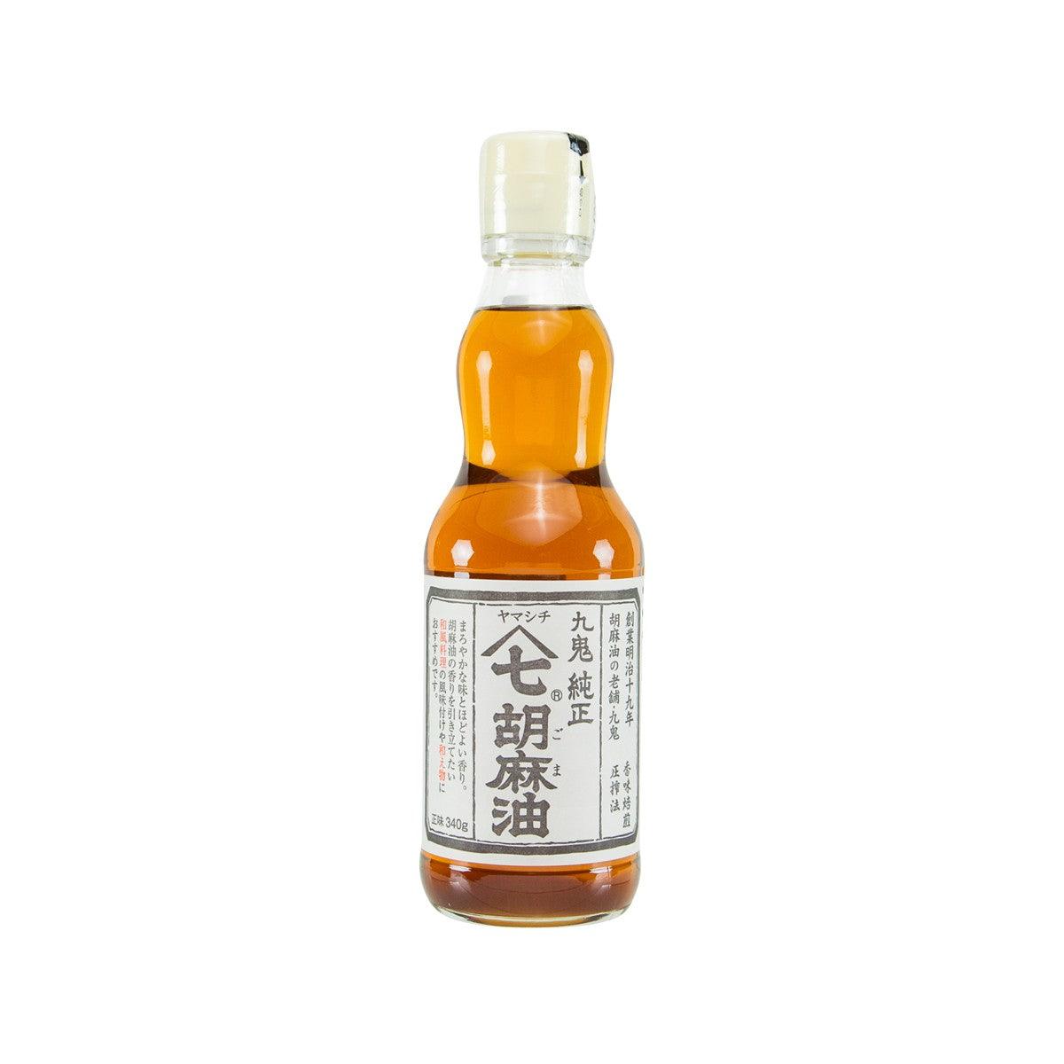 KUKI pure sesame oil bottle, amber glass with white label and black cap