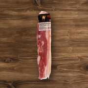 Bone-in skin-on pork belly, vacuum-sealed pack with label; raw pink meat and pale fat