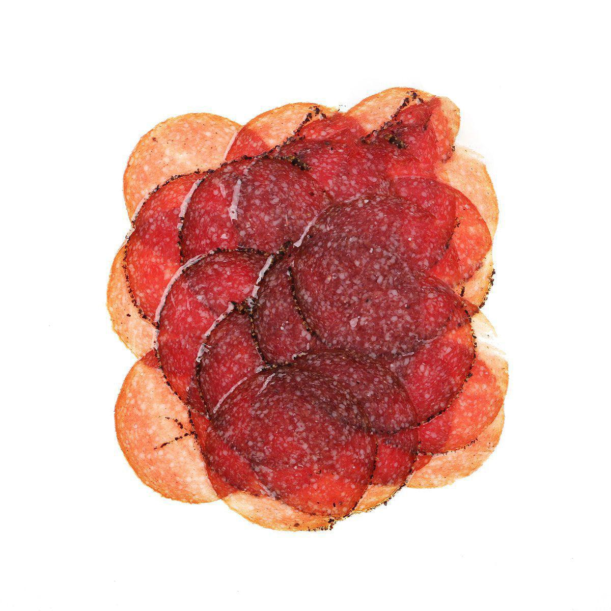 Pepper-coated salami slices, red cured meat rounds with black pepper specks