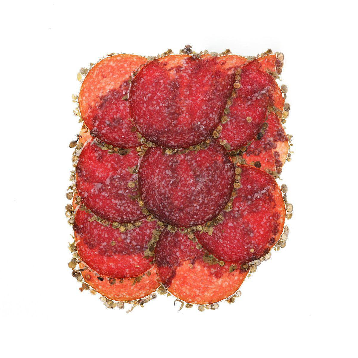 Red pepper-coated salami slices with green pepper specks