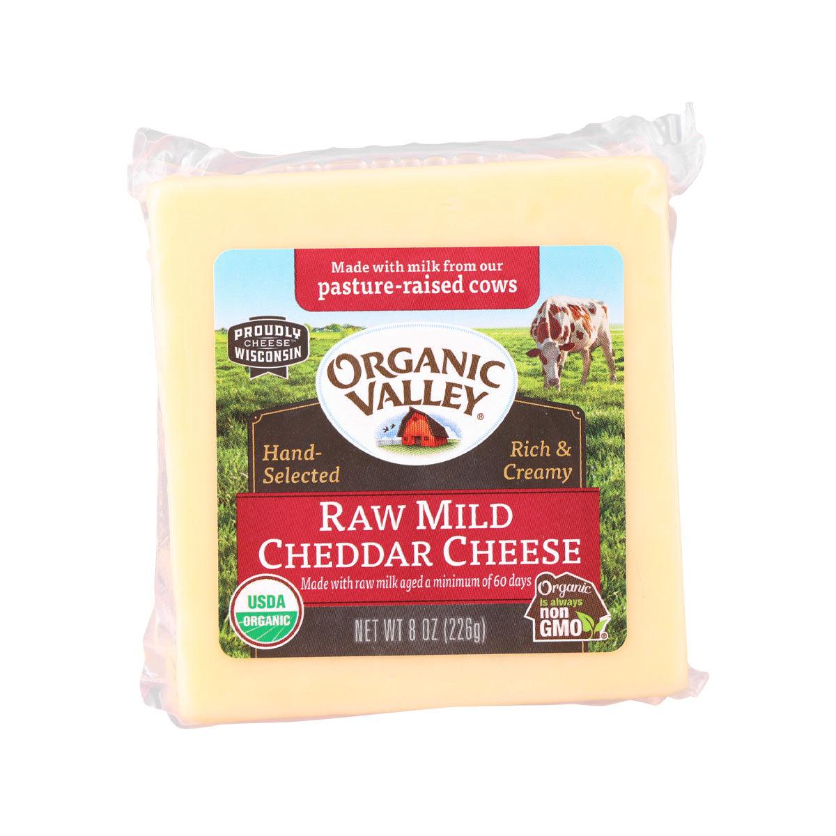 Raw mild cheddar cheese block in plastic wrap with organic front label, 226 g