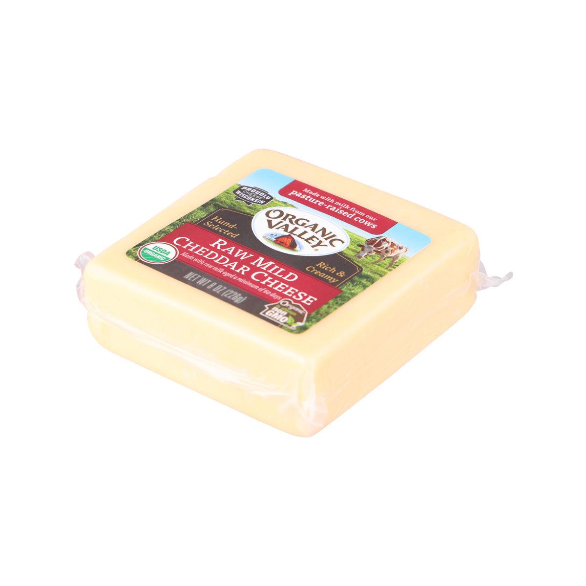 Raw mild cheddar cheese block, 226 g, sealed in plastic wrap with top label