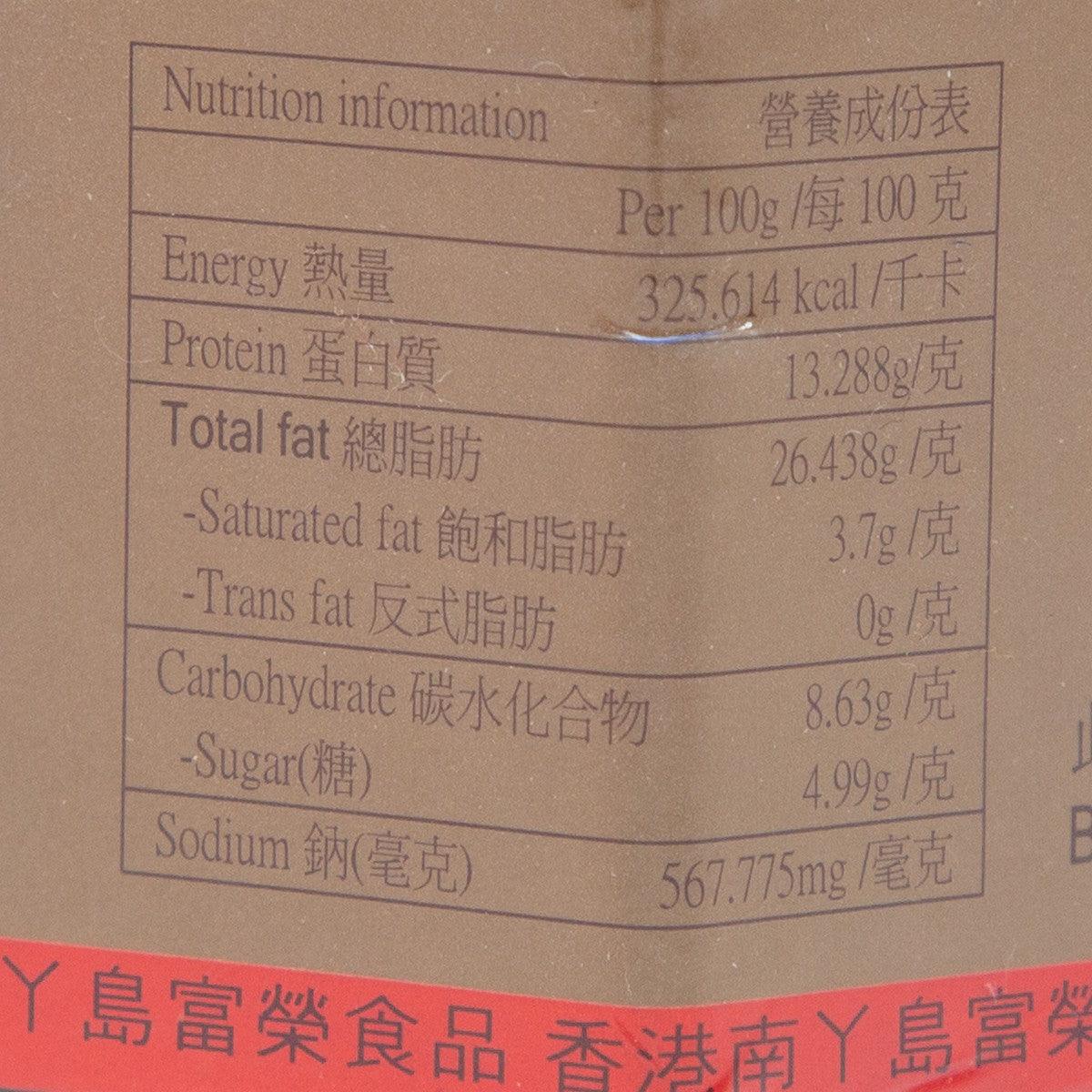 Nutrition information label close-up on shrimp sauce jar, beige panel with table.