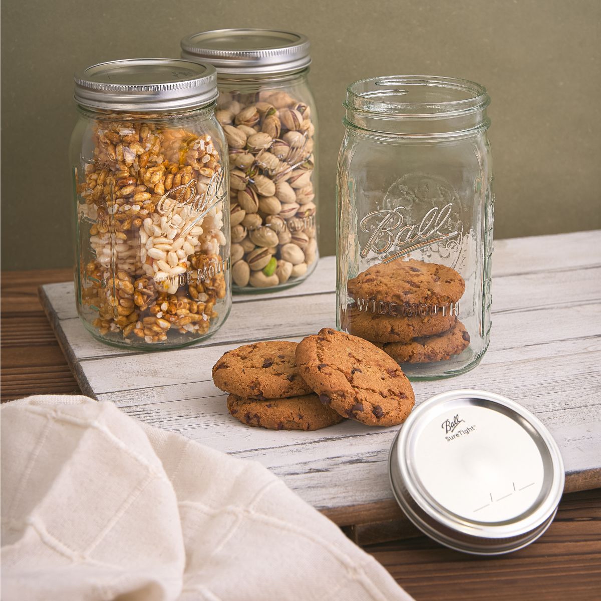 Set of three wide-mouth glass mason jars with metal lids