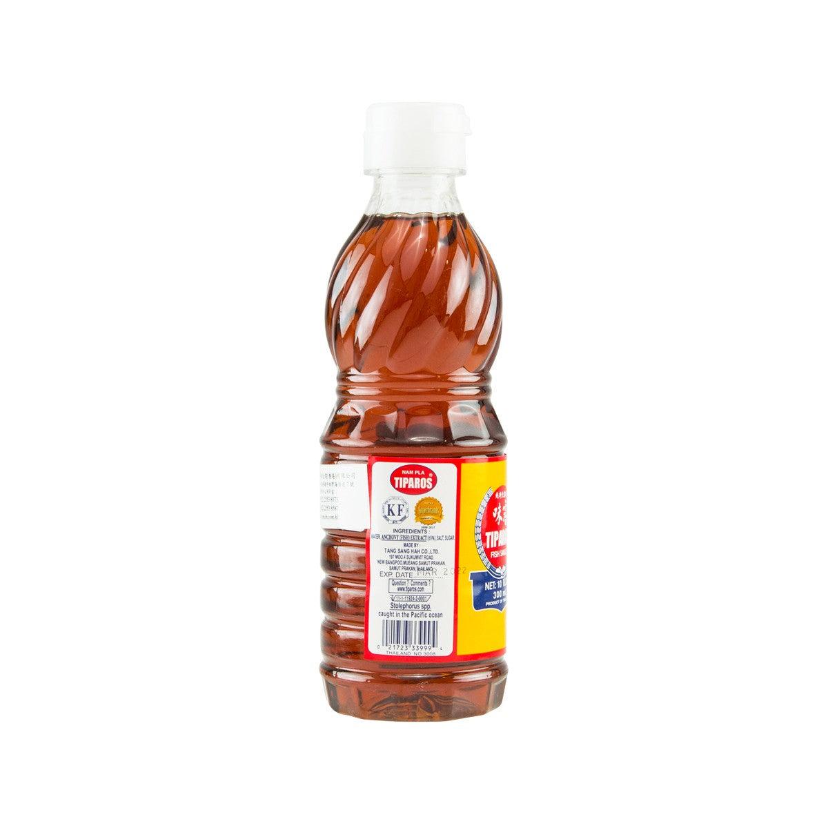 Fish sauce bottle back view with label, amber brown liquid, and white screw cap