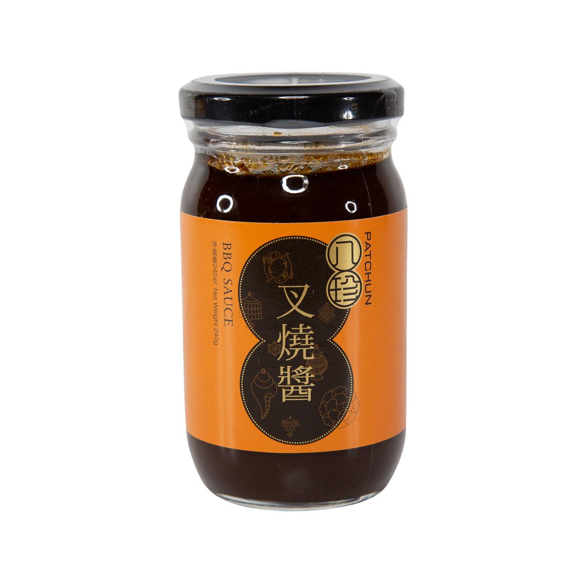BBQ sauce jar with orange front label and dark brown sauce, black screw cap