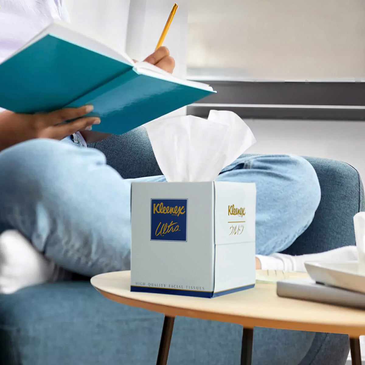 KLEENEX Ultra small tissue box on table with tissues pulled up