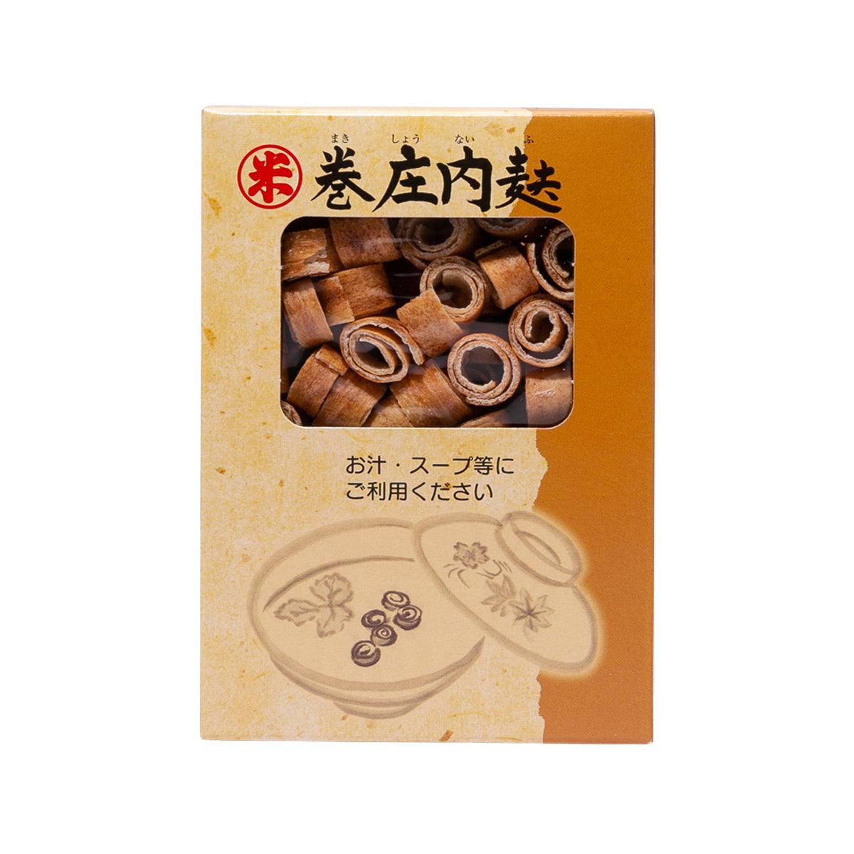 Roasted wheat gluten in box with viewing window showing curled roasted pieces