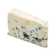 Roquefort blue cheese wedge with creamy white interior and blue veining