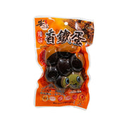 Spicy preserved eggs in orange plastic pouch with black eggs and cartoon label