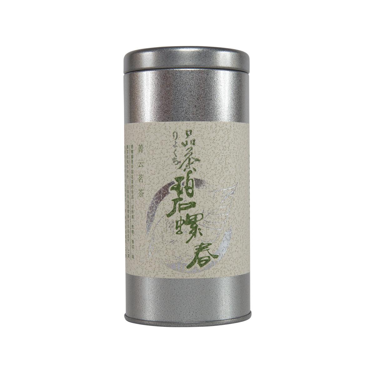 Silver metal tea canister with beige label and green characters
