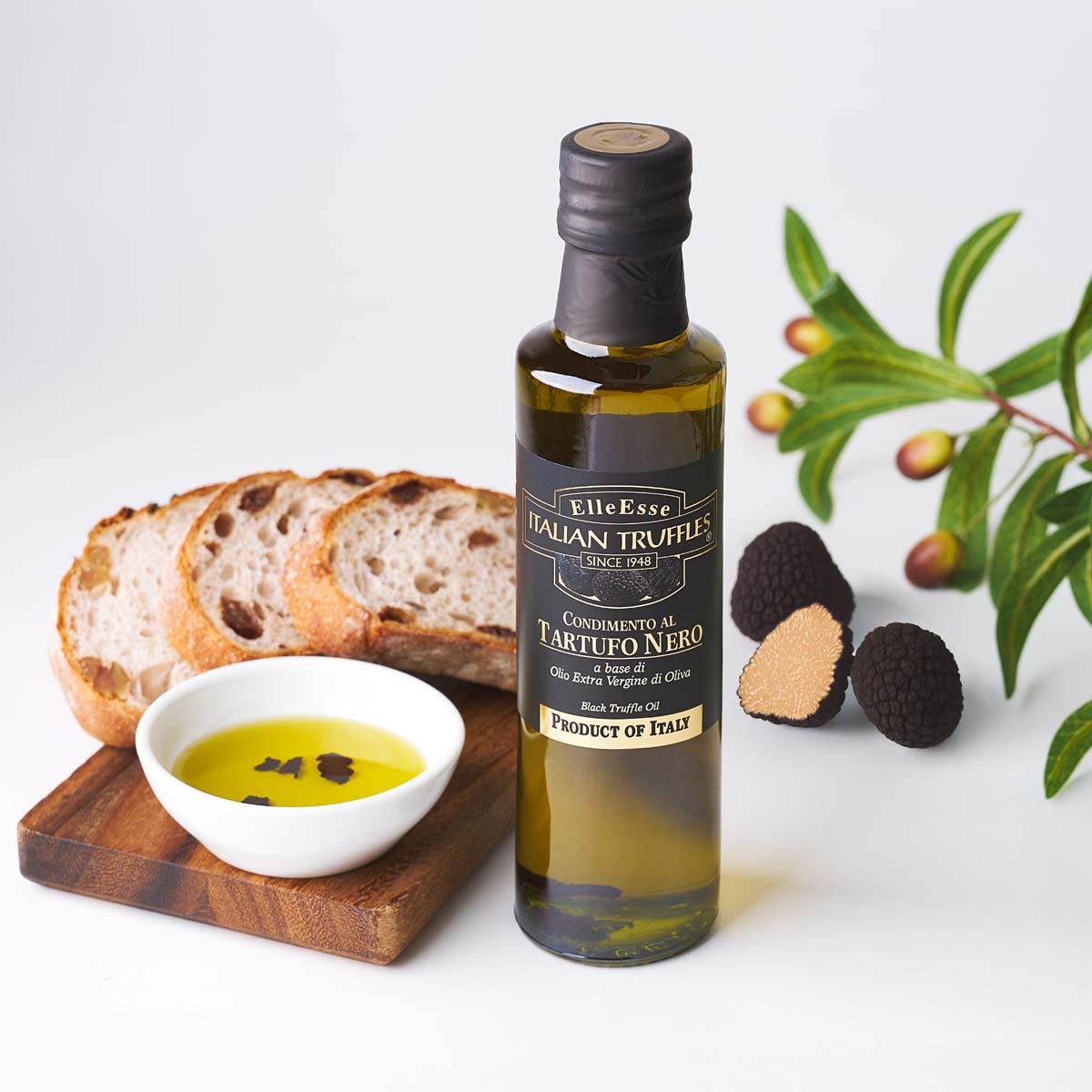Truffle extra virgin olive oil bottle with black cap and label, with truffles