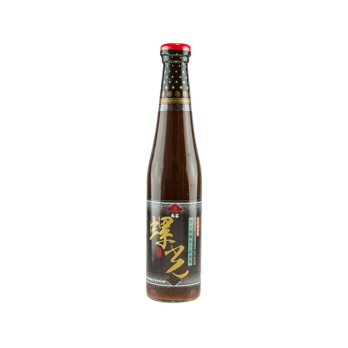 Condensed soy paste bottle with red cap, brown glass, and dark label