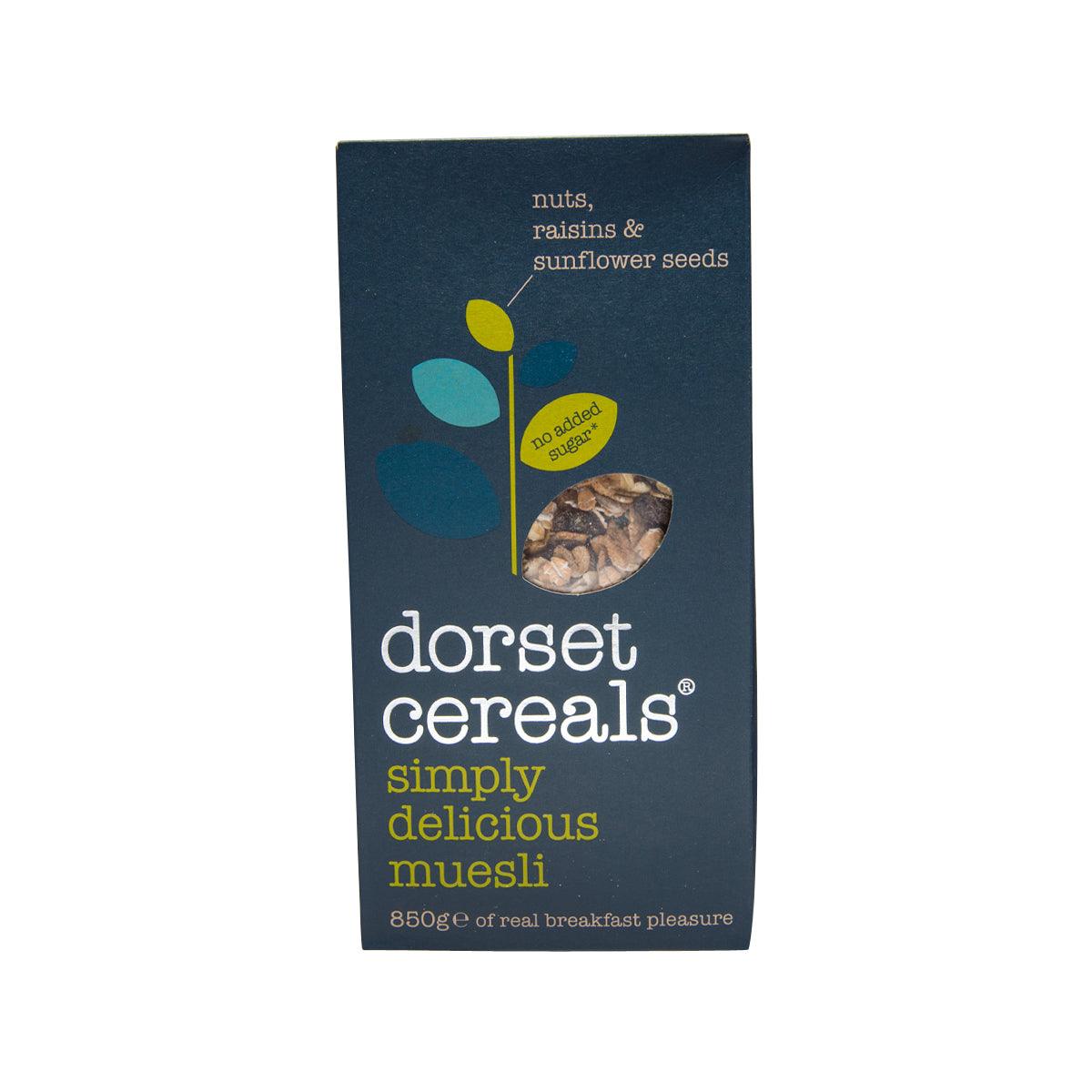 Dark blue muesli cereal box with seed icons and small product window on front