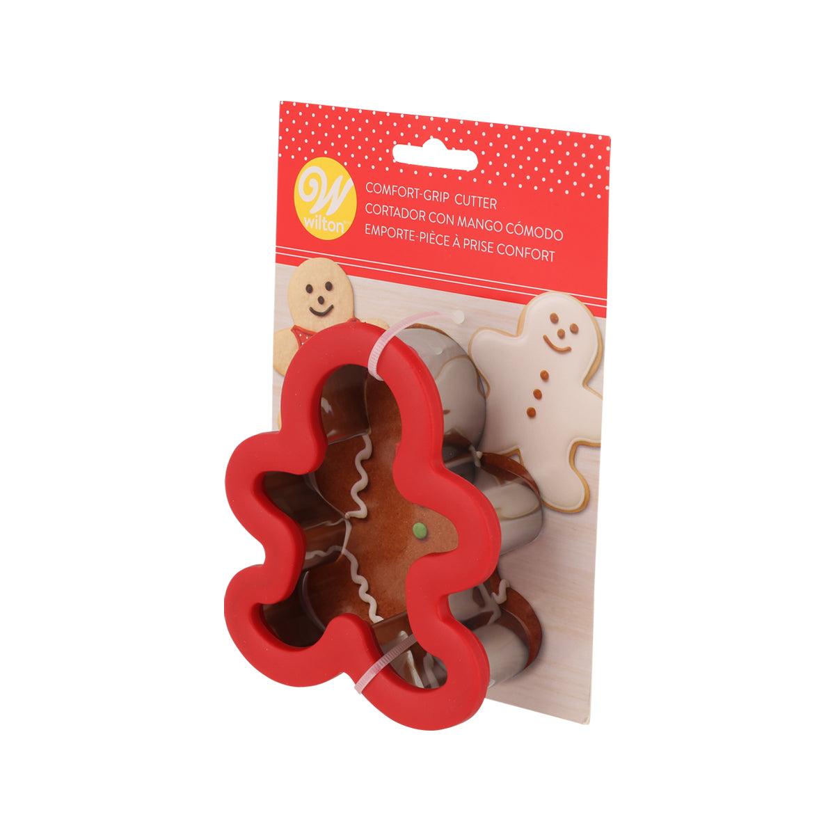 Gingerbread boy cookie cutter with comfort-grip handle, red outline, in retail package