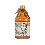 Amber umeshu bottle with gold foil top and red tied ribbon; illustrated label