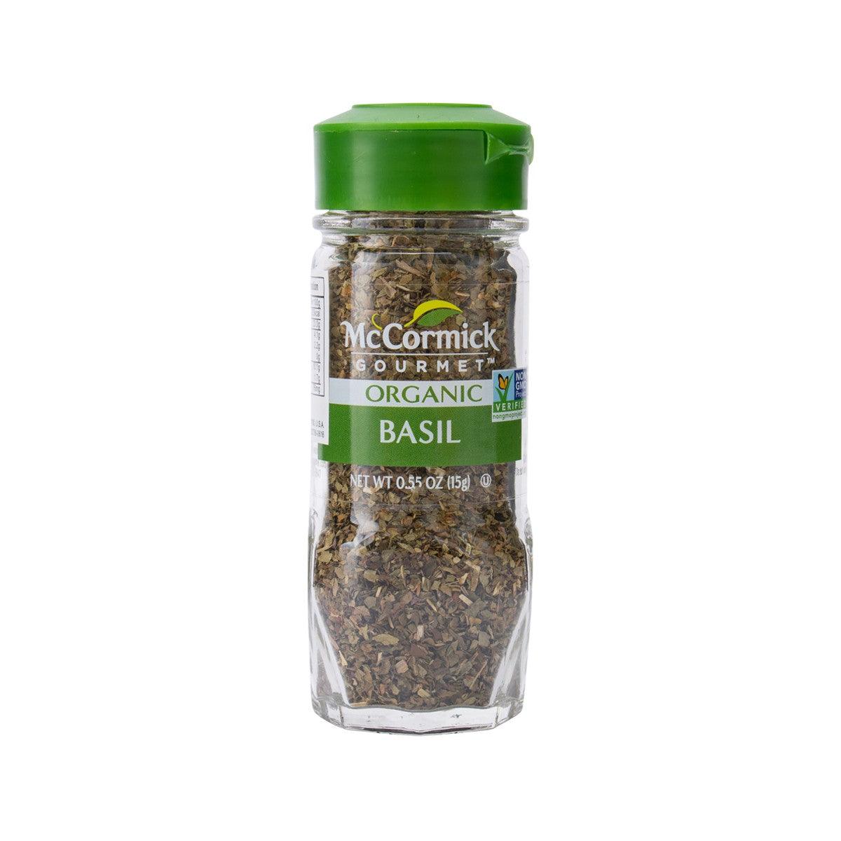 Organic basil seasoning bottle, green cap, clear glass jar with dried herbs label
