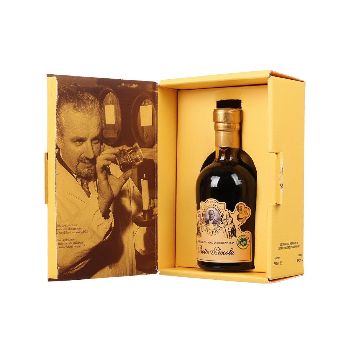Balsamic vinegar bottle in open gift box with gold cap