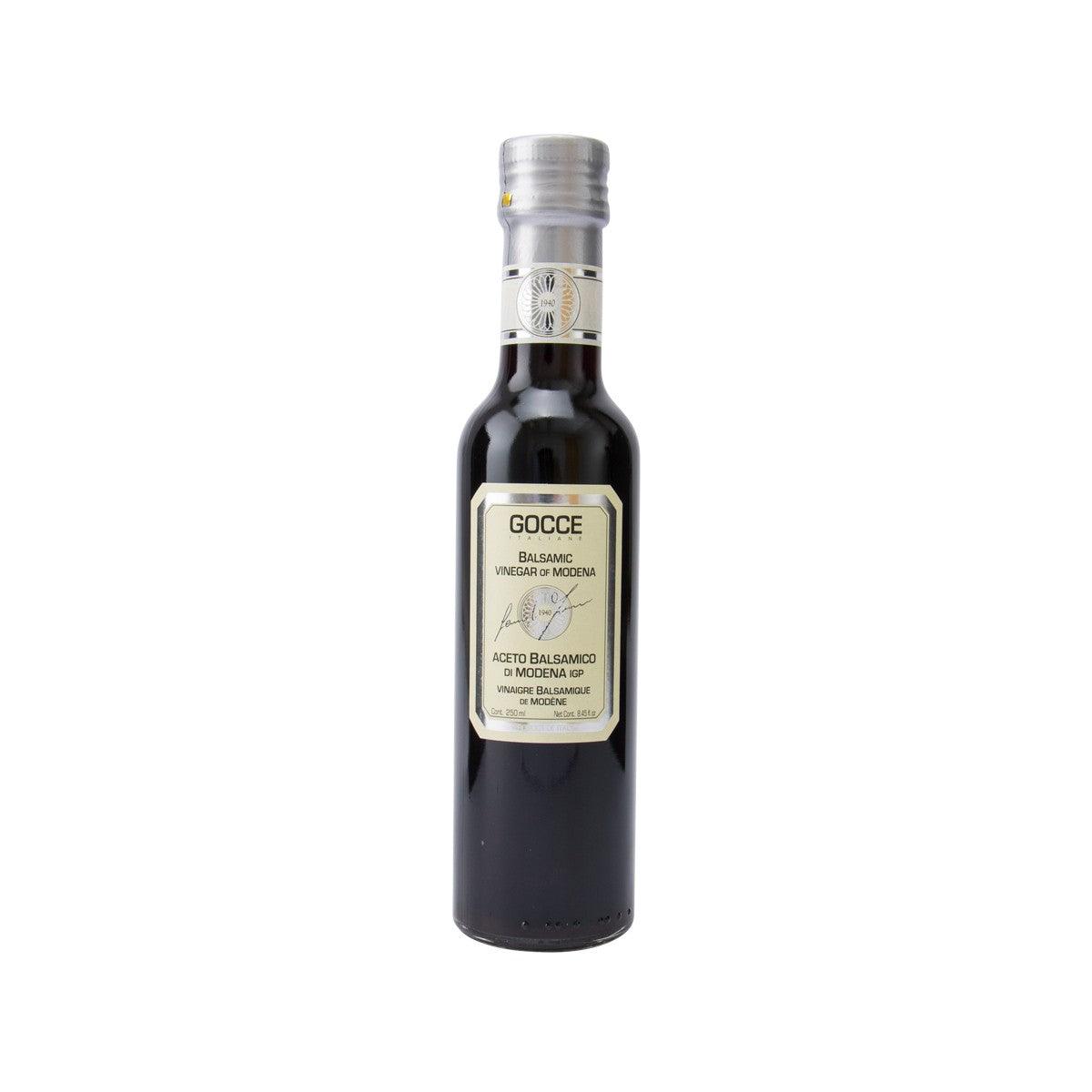 Balsamic vinegar bottle with silver cap and GOCCE front label on dark glass