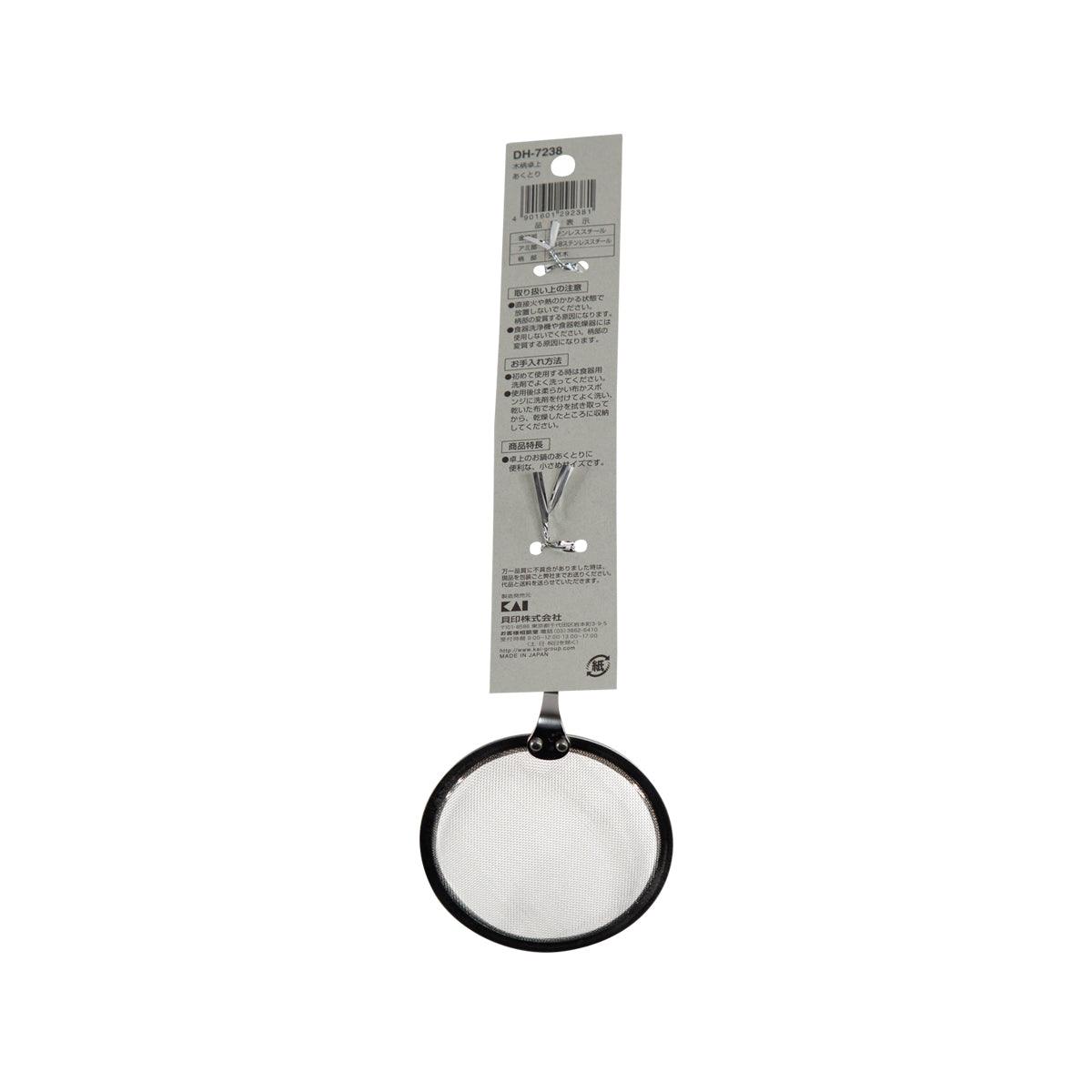 KAI strainer with round mesh basket, black rim, shown on hanging card