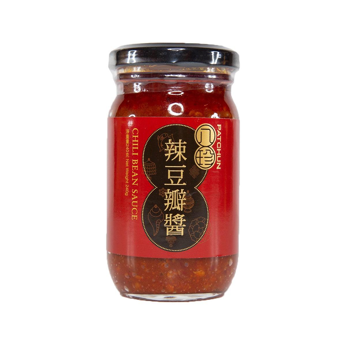 Red chili bean sauce in glass jar with black screw lid