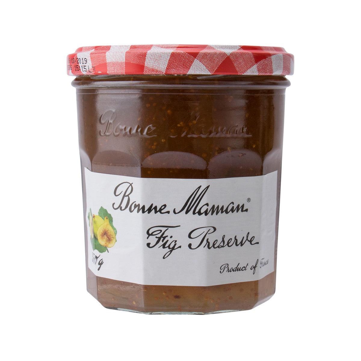 Glass jar of fig preserve with red gingham lid
