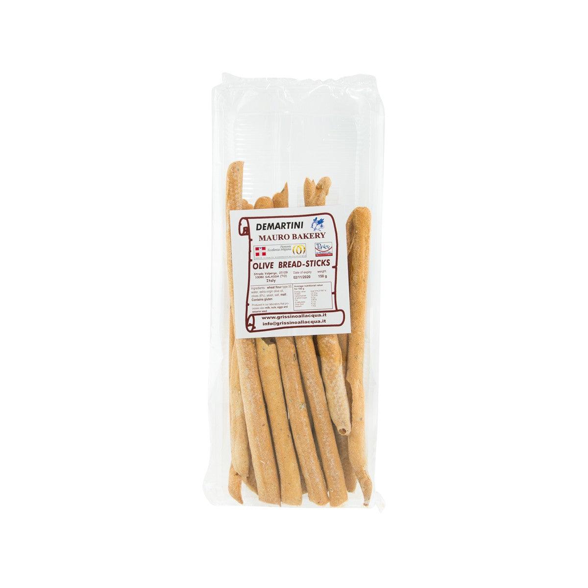 Olive breadsticks in clear plastic bag, yellow-brown sticks with front label