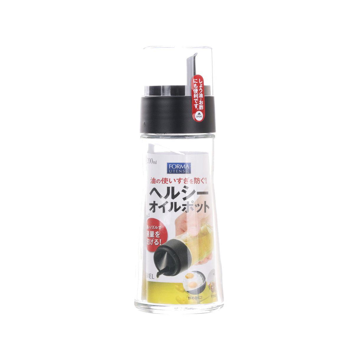 Transparent oil dispenser bottle with black pump top and side label, 200 mL
