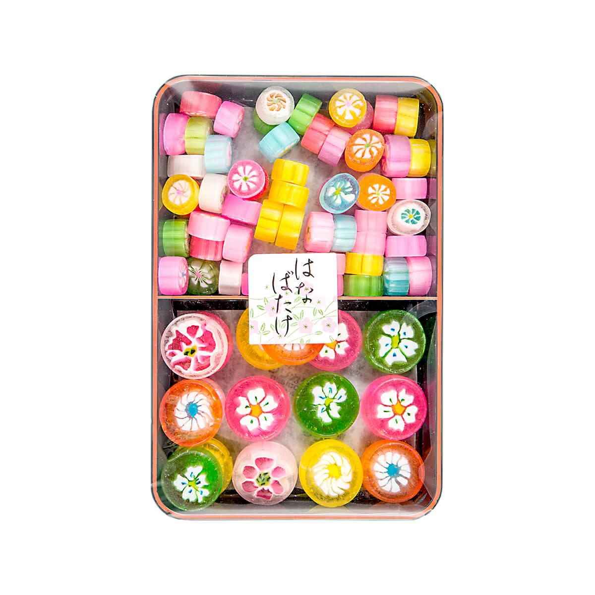Art candies assortment in a metal tin, colorful round and striped wrapped pieces