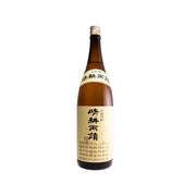 Imo shochu bottle with amber glass, cream front label, and gold foil cap.